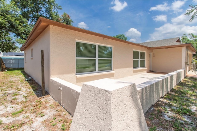 11210 Wheeling Dr, Tampa, FL 33625 - back of house featuring stucco siding and a patio area