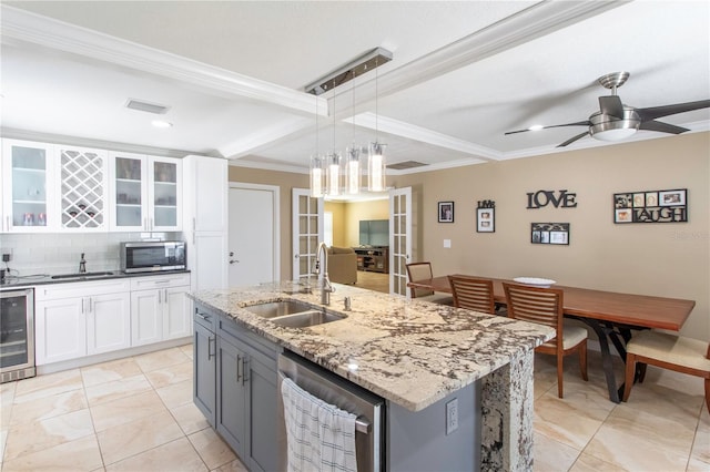 11210 Wheeling Dr, Tampa, FL 33625 - kitchen featuring a sink, appliances with stainless steel finishes, beverage cooler, crown molding, and white cabinetry
