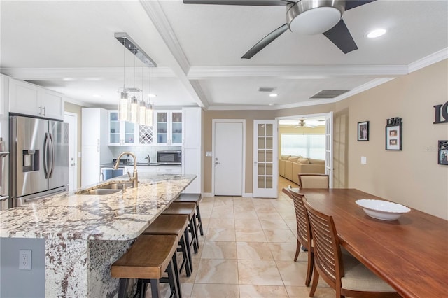 11210 Wheeling Dr, Tampa, FL 33625 - kitchen featuring appliances with stainless steel finishes, a ceiling fan, a sink, crown molding, and glass insert cabinets