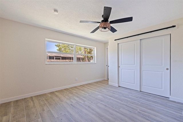 unfurnished bedroom with baseboards and wood finished floors