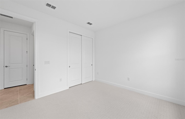 17200 Luminous Ave, Venice, FL 34293 - unfurnished bedroom featuring light colored carpet, baseboards, and a closet