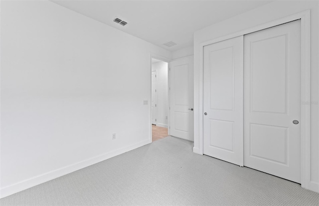 17200 Luminous Ave, Venice, FL 34293 - unfurnished bedroom featuring baseboards, a closet, and light colored carpet