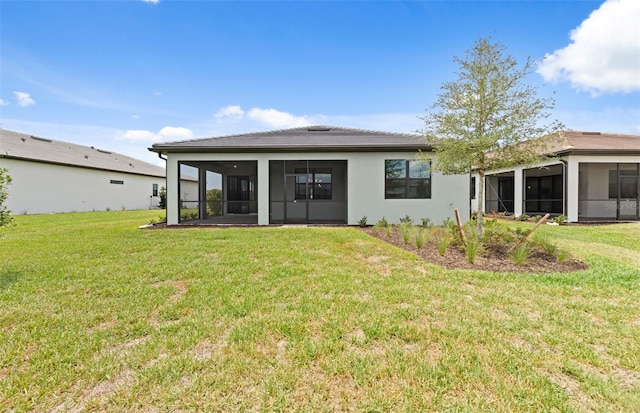 17200 Luminous Ave, Venice, FL 34293 - back of property featuring a sunroom and a lawn