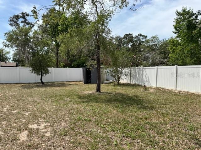 view of yard with a fenced backyard