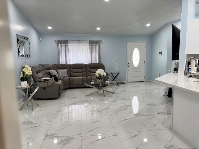 living area featuring recessed lighting, baseboards, and marble finish floor