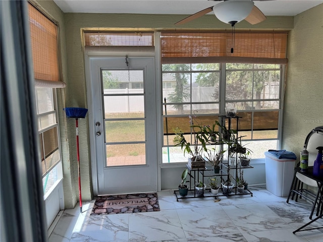 sunroom with a ceiling fan