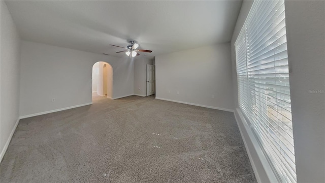 105 Evergreen Dr, Auburndale, FL 33823 - carpeted empty room with baseboards, a ceiling fan, and arched walkways