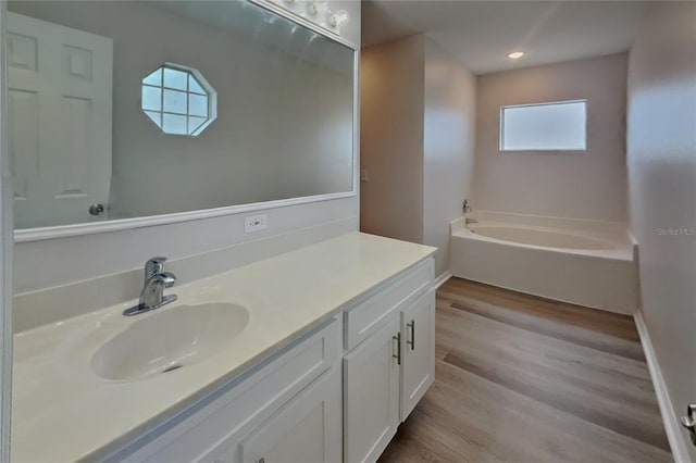 105 Evergreen Dr, Auburndale, FL 33823 - full bathroom featuring recessed lighting, baseboards, a bath, vanity, and wood finished floors