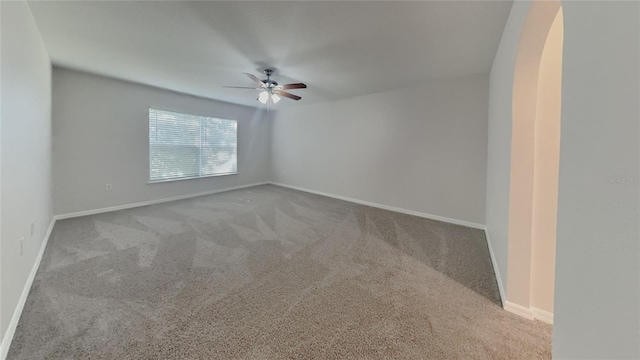 105 Evergreen Dr, Auburndale, FL 33823 - carpeted empty room featuring arched walkways, baseboards, and ceiling fan