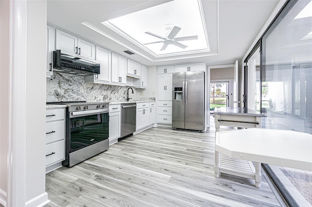 4137 Northmeadow Cir, Tampa, FL 33618 - kitchen with stainless steel appliances, a tray ceiling, extractor fan, ceiling fan, and light countertops