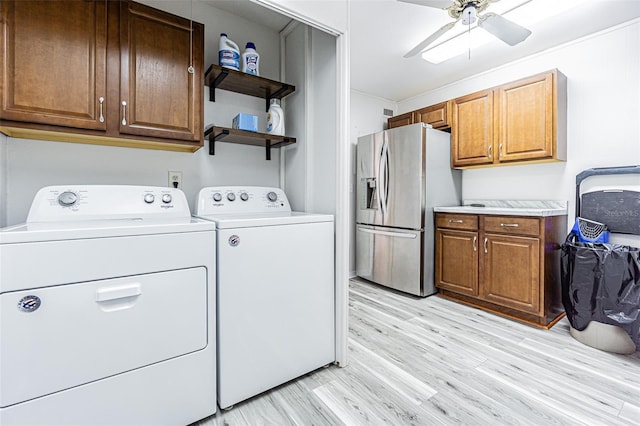 4137 Northmeadow Cir, Tampa, FL 33618 - laundry room with light wood-style flooring, a ceiling fan, crown molding, washer and dryer, and laundry area