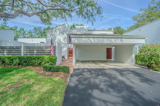 4137 Northmeadow Cir, Tampa, FL 33618 - view of front of home with fence, driveway, and stucco siding