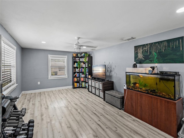 living area featuring visible vents, baseboards, recessed lighting, wood finished floors, and a ceiling fan