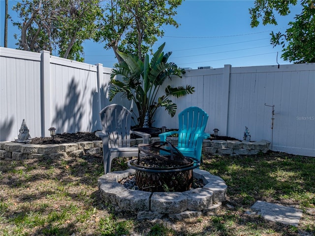 view of yard featuring fence and a fire pit