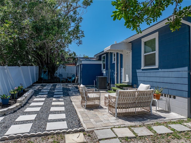 view of patio / terrace featuring outdoor lounge area, a fenced backyard, and central AC unit