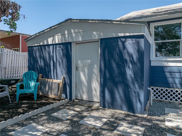 view of shed featuring fence