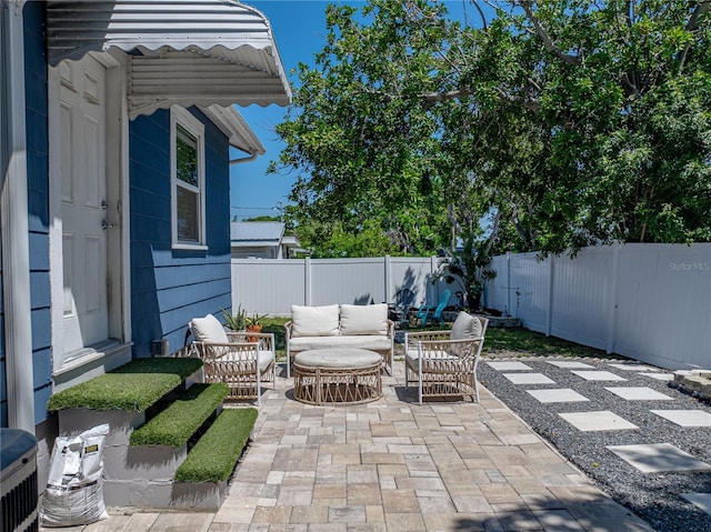 view of patio with an outdoor living space and a fenced backyard