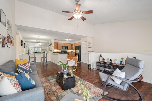 5636 Baywater Dr Unit 5636, Tampa, FL 33615 - living area with baseboards, a ceiling fan, a textured ceiling, and dark wood-style flooring