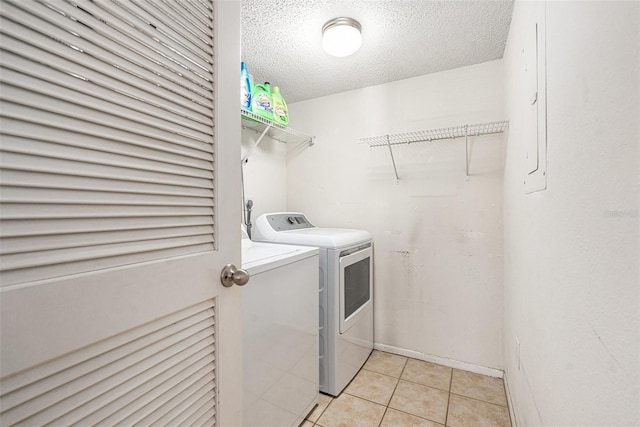 5636 Baywater Dr Unit 5636, Tampa, FL 33615 - laundry room with light tile patterned floors, electric panel, laundry area, a textured ceiling, and washer and dryer