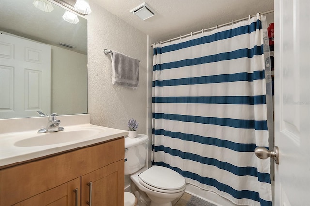 5636 Baywater Dr Unit 5636, Tampa, FL 33615 - bathroom featuring a textured wall, toilet, visible vents, and vanity