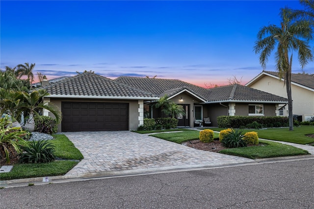 6129 Leeland St S, Saint Petersburg, FL 33715 - single story home featuring a garage, a tile roof, a front yard, and stucco siding