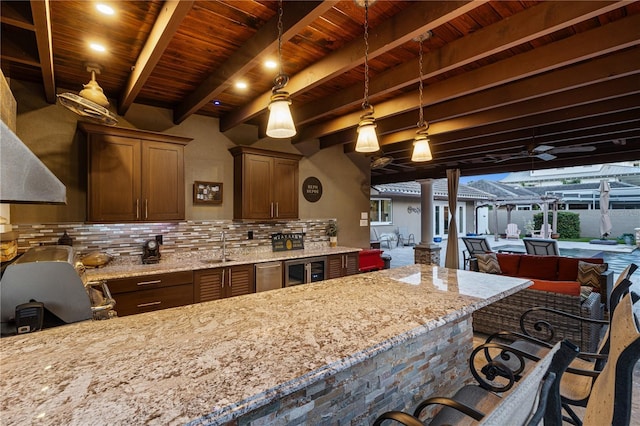 6129 Leeland St S, Saint Petersburg, FL 33715 - kitchen with wood ceiling, light stone countertops, backsplash, and hanging light fixtures
