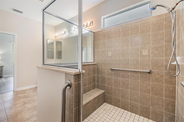 7815 Blue Spring Dr, Land O Lakes, FL 34637 - bathroom with baseboards, tile patterned flooring, visible vents, and tiled shower