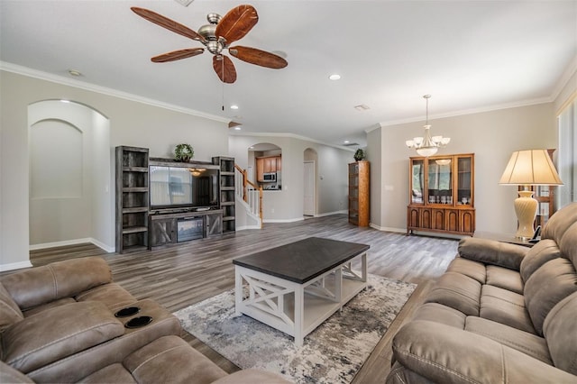 7815 Blue Spring Dr, Land O Lakes, FL 34637 - living area with ceiling fan with notable chandelier, baseboards, arched walkways, and crown molding