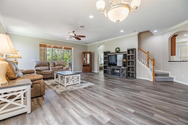 7815 Blue Spring Dr, Land O Lakes, FL 34637 - living room with wood finished floors, ornamental molding, arched walkways, baseboards, and ceiling fan with notable chandelier