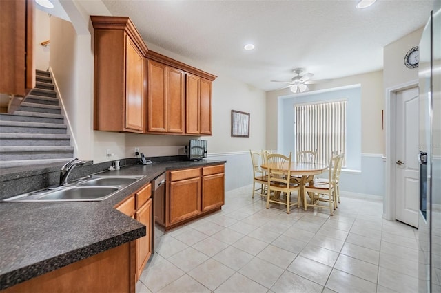 7815 Blue Spring Dr, Land O Lakes, FL 34637 - kitchen featuring dark countertops, dishwasher, a ceiling fan, a sink, and brown cabinetry