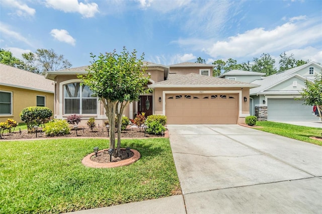 7815 Blue Spring Dr, Land O Lakes, FL 34637 - view of front facade featuring an attached garage, driveway, a front yard, and stucco siding