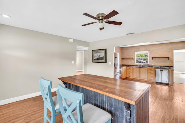 250 W Canal Dr, Palm Harbor, FL 34684 - kitchen with appliances with stainless steel finishes, open shelves, wood counters, and light wood finished floors