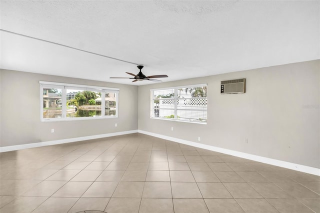 250 W Canal Dr, Palm Harbor, FL 34684 - unfurnished room featuring a wall unit AC, a ceiling fan, and light tile patterned floors