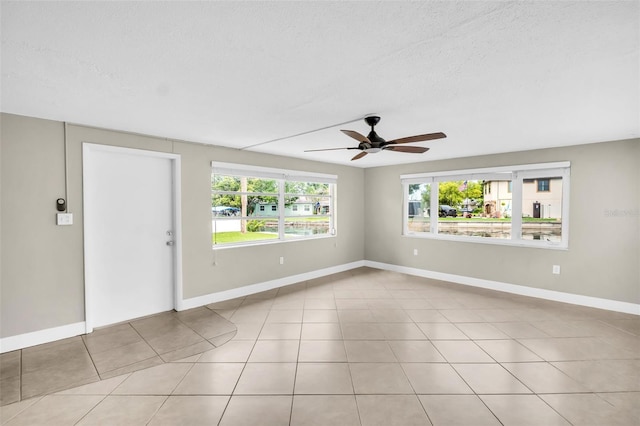 250 W Canal Dr, Palm Harbor, FL 34684 - spare room featuring a ceiling fan and a textured ceiling