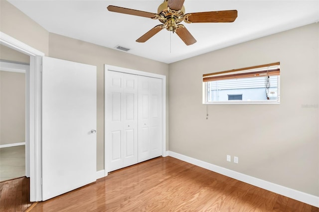 250 W Canal Dr, Palm Harbor, FL 34684 - unfurnished bedroom featuring light wood finished floors, a closet, and ceiling fan