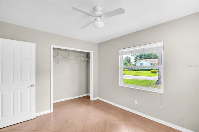 250 W Canal Dr, Palm Harbor, FL 34684 - unfurnished bedroom featuring a closet, tile patterned flooring, and a ceiling fan