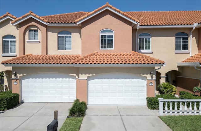6303 Vista Verde Dr E, Gulfport, FL 33707 - mediterranean / spanish house featuring a garage, stucco siding, driveway, and a tile roof