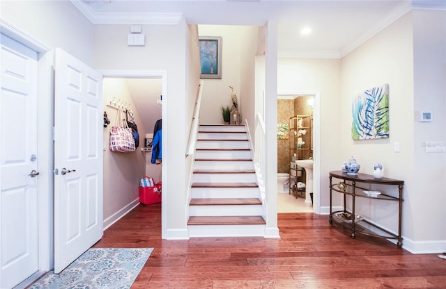 6303 Vista Verde Dr E, Gulfport, FL 33707 - entrance foyer with crown molding, baseboards, stairs, and wood finished floors