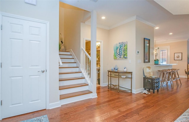 6303 Vista Verde Dr E, Gulfport, FL 33707 - staircase featuring crown molding, recessed lighting, and wood finished floors