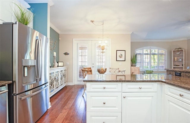 6303 Vista Verde Dr E, Gulfport, FL 33707 - kitchen featuring crown molding, stone counters, wood finished floors, white cabinets, and stainless steel fridge