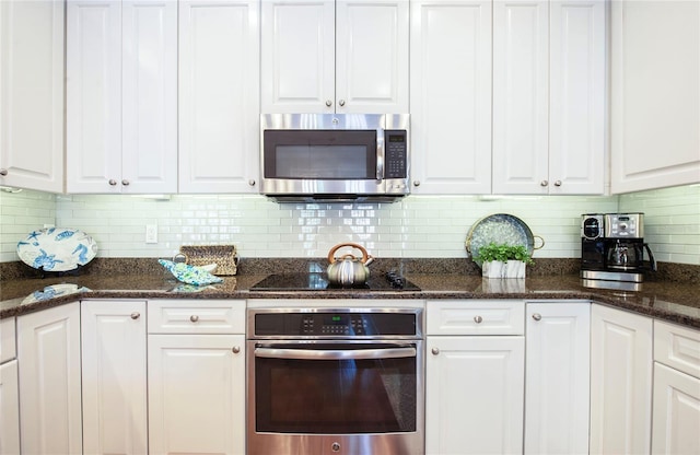 6303 Vista Verde Dr E, Gulfport, FL 33707 - kitchen with white cabinets and appliances with stainless steel finishes