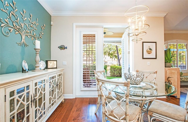 6303 Vista Verde Dr E, Gulfport, FL 33707 - dining space featuring baseboards, ornamental molding, wood finished floors, and a notable chandelier