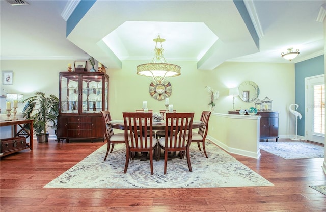 6303 Vista Verde Dr E, Gulfport, FL 33707 - dining room with an inviting chandelier, ornamental molding, baseboards, and wood finished floors