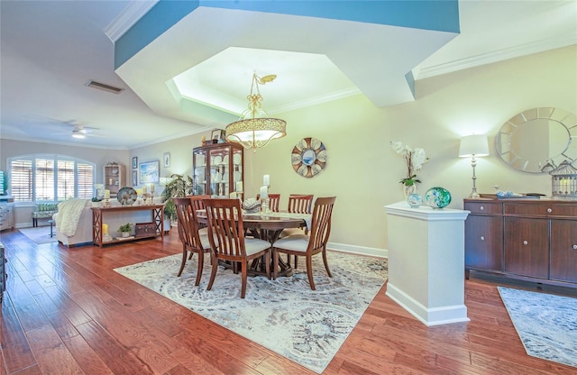 6303 Vista Verde Dr E, Gulfport, FL 33707 - dining room with visible vents, baseboards, crown molding, and wood finished floors