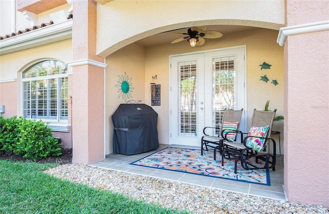 6303 Vista Verde Dr E, Gulfport, FL 33707 - entrance to property with french doors, a patio, a ceiling fan, and stucco siding