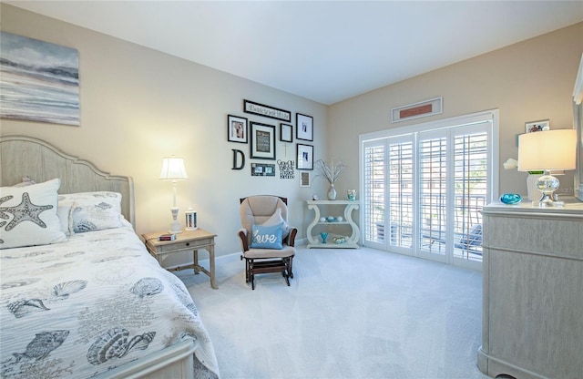 6303 Vista Verde Dr E, Gulfport, FL 33707 - bedroom with baseboards, carpet flooring, and access to exterior