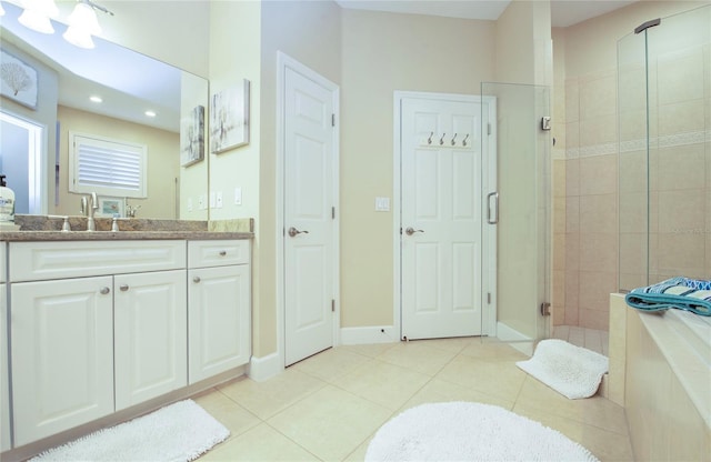 6303 Vista Verde Dr E, Gulfport, FL 33707 - bathroom with a bath, tile patterned flooring, a stall shower, vanity, and recessed lighting