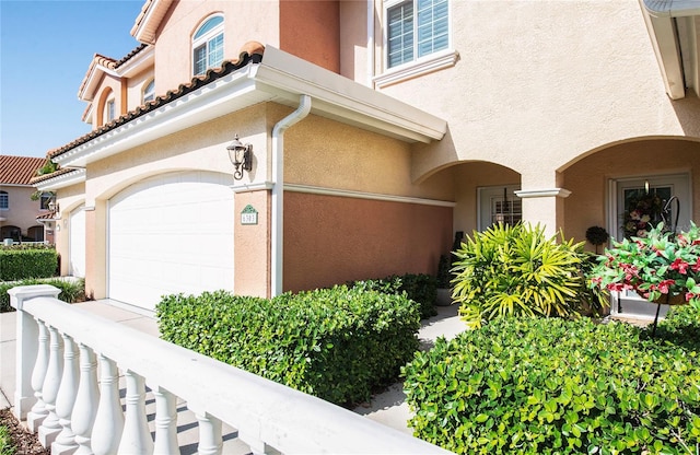 6303 Vista Verde Dr E, Gulfport, FL 33707 - view of side of home featuring stucco siding and an attached garage