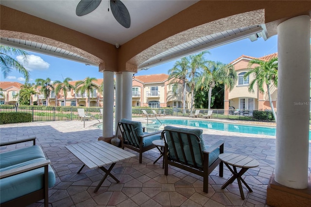 6303 Vista Verde Dr E, Gulfport, FL 33707 - view of patio / terrace featuring fence, a ceiling fan, and a community pool
