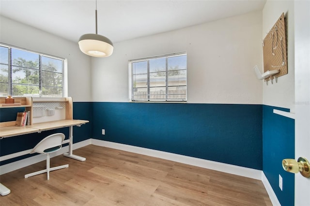 home office featuring wood finished floors and baseboards